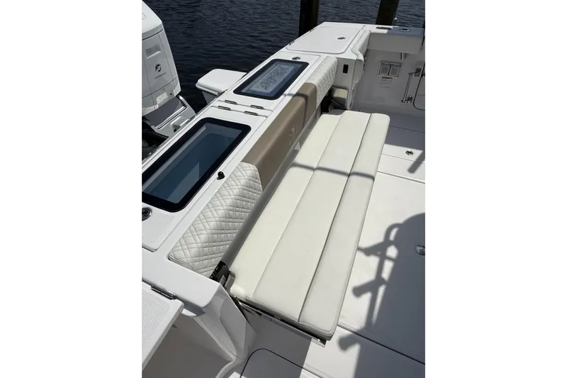  Yacht Photos Pics 2024 Bertram 39 CC boat interior with cushioned seating and storage compartments.