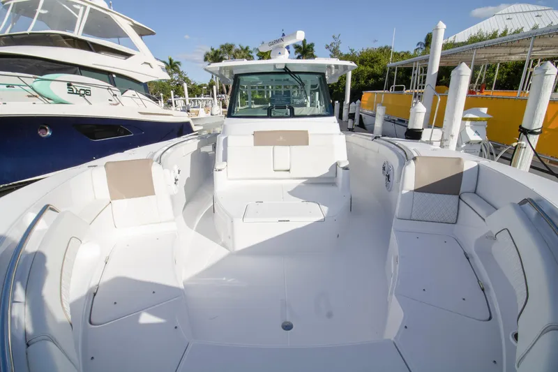  Yacht Photos Pics 2024 Bertram 39 CC boat interior, spacious seating, docked at marina.