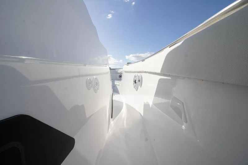  Yacht Photos Pics 2024 Bertram 39 CC boat deck with sleek white design under clear blue sky.