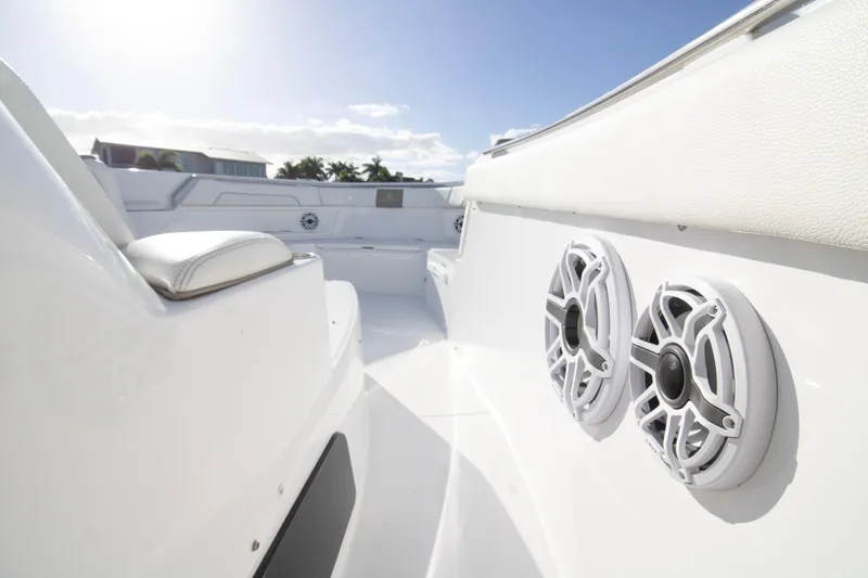  Yacht Photos Pics 2024 Bertram 39 CC boat interior with speakers and seating, under clear blue sky.