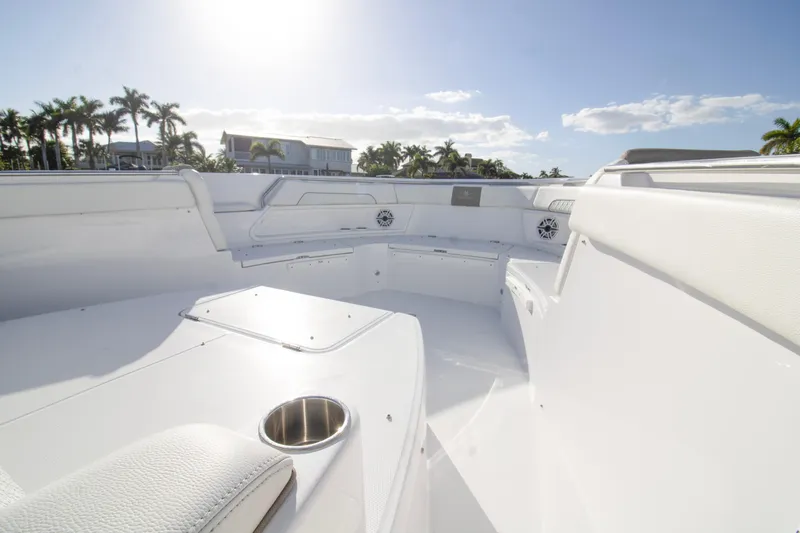  Yacht Photos Pics 2024 Bertram 39 CC boat interior with sleek white seating and cup holder.