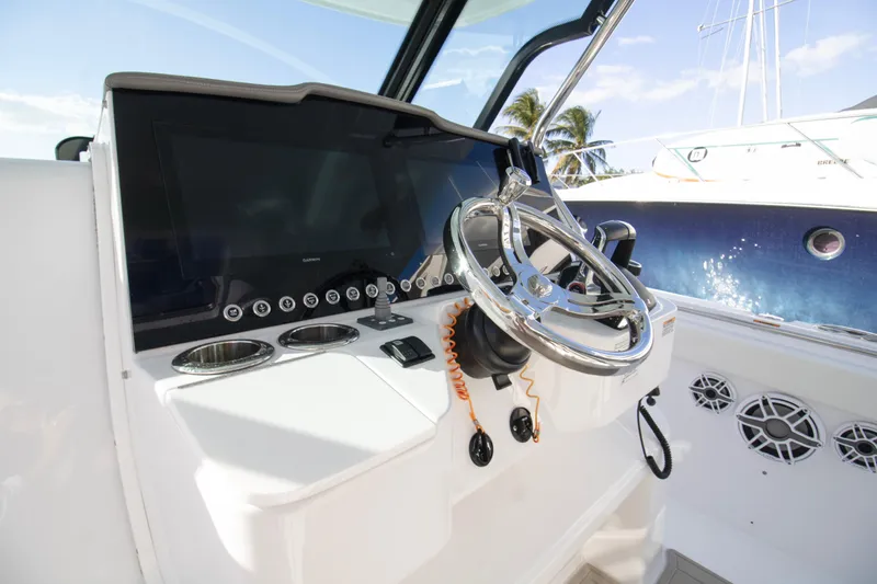  Yacht Photos Pics 2024 Bertram 39 CC helm with modern controls and sleek steering wheel.