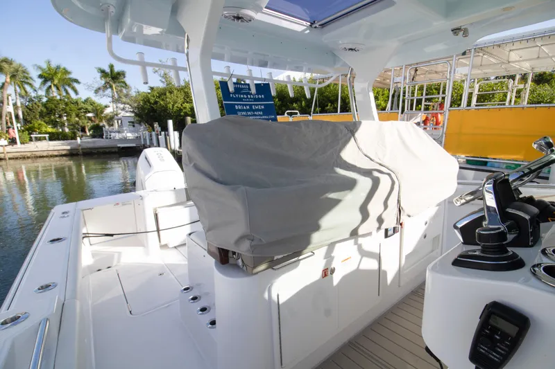  Yacht Photos Pics 2024 Bertram 39 CC boat interior with covered seating and control panel.