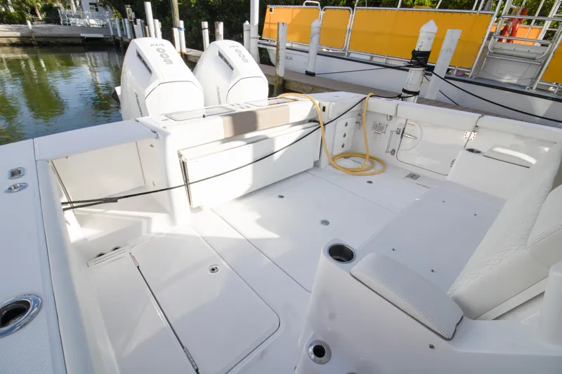  Yacht Photos Pics 2024 Bertram 39 CC boat deck with twin outboard engines, docked at marina.