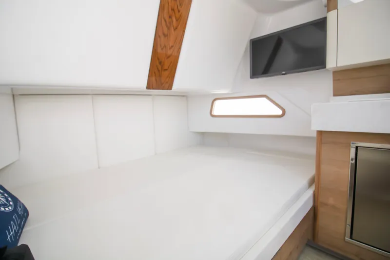  Yacht Photos Pics 2024 Bertram 39 CC cabin interior with bed, TV, and modern design elements.