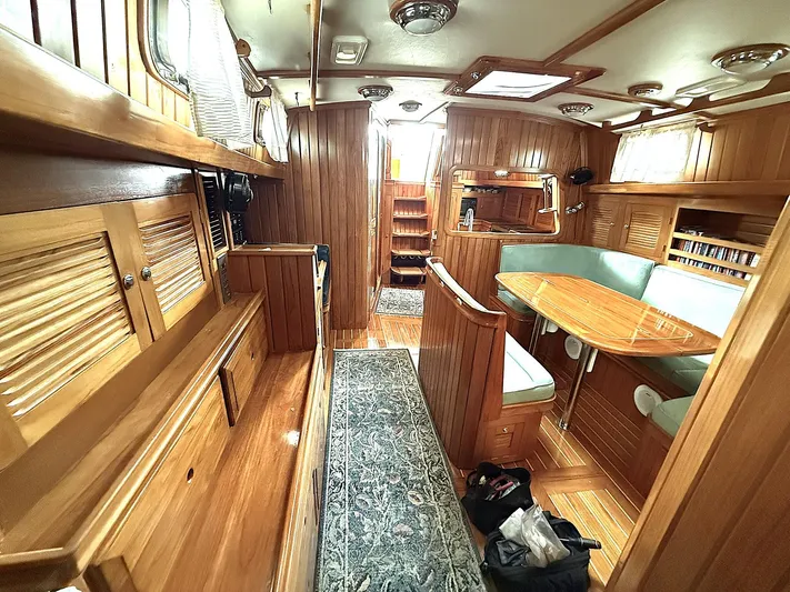 Sarah Yacht Photos Pics Luxurious 2000 Cabo Rico Pearl Edition yacht interior with wood finish and cozy seating area.