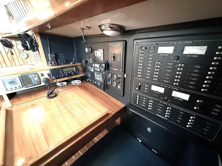 Sarah Yacht Photos Pics Navigation station of 2000 Cabo Rico Pearl Edition yacht with control panels and communication equipment.