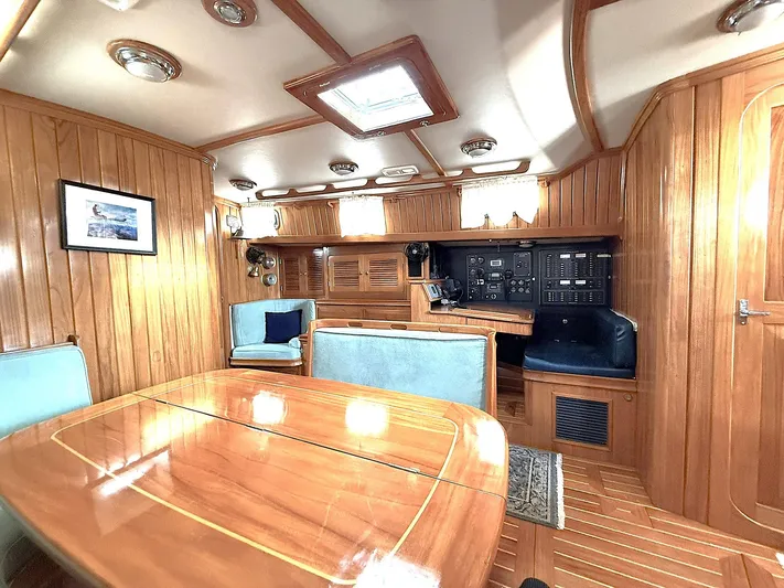 Sarah Yacht Photos Pics Luxurious 2000 Cabo Rico Pearl Edition yacht interior with wood paneling and elegant seating.