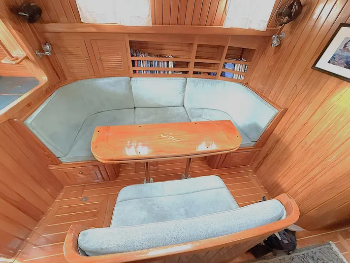 Sarah Yacht Photos Pics Cabo Rico 2000 Pearl Edition yacht interior with wooden finish and cushioned seating.