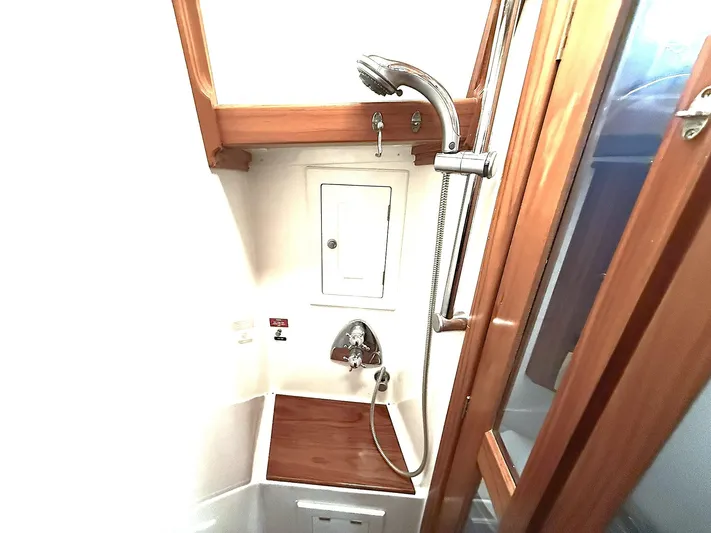 Sarah Yacht Photos Pics Cabo Rico 2000 Pearl Edition yacht shower with wooden accents and modern fixtures.