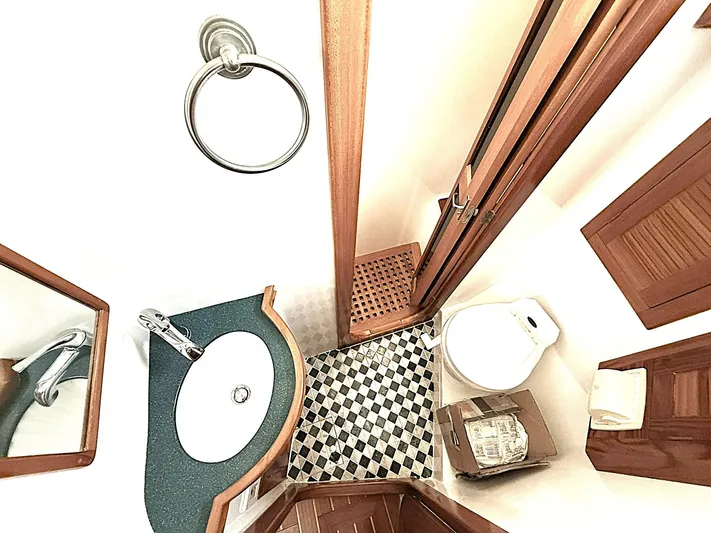 Sarah Yacht Photos Pics Luxurious bathroom in 2000 Cabo Rico Pearl Edition yacht, featuring elegant wood accents and modern fixtures.