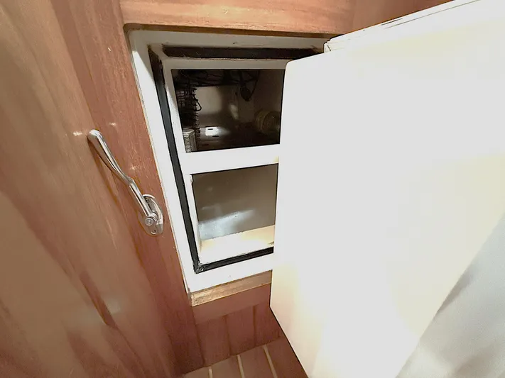 Sarah Yacht Photos Pics Cabo Rico Pearl Edition 2000 yacht interior with open storage compartment.