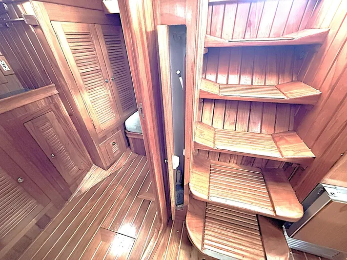 Sarah Yacht Photos Pics Interior of 2000 Cabo Rico Pearl Edition yacht with wooden stairs and cabinetry.