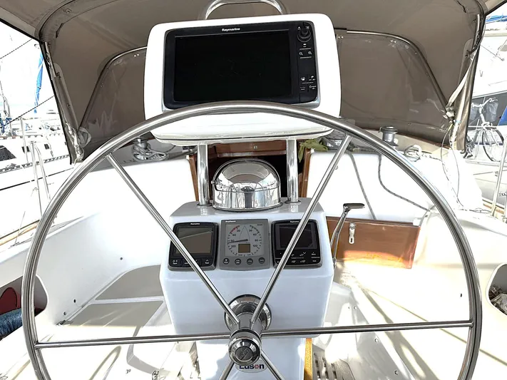 Sarah Yacht Photos Pics Steering wheel and navigation equipment on 2000 Cabo Rico Pearl Edition yacht.