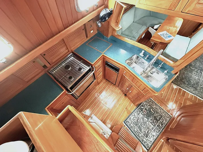 Sarah Yacht Photos Pics Luxurious Cabo Rico Pearl Edition 2000 yacht interior with wood finish and modern kitchen amenities.