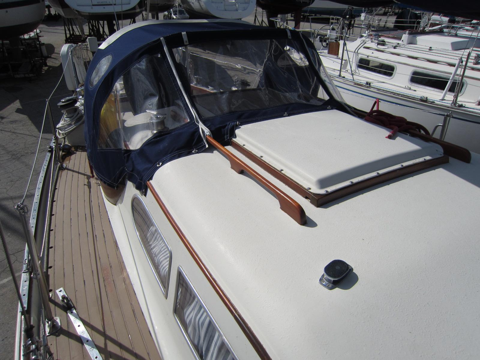 1969 Chris-Craft Apache 37 sailboat with blue canopy and wooden deck details.