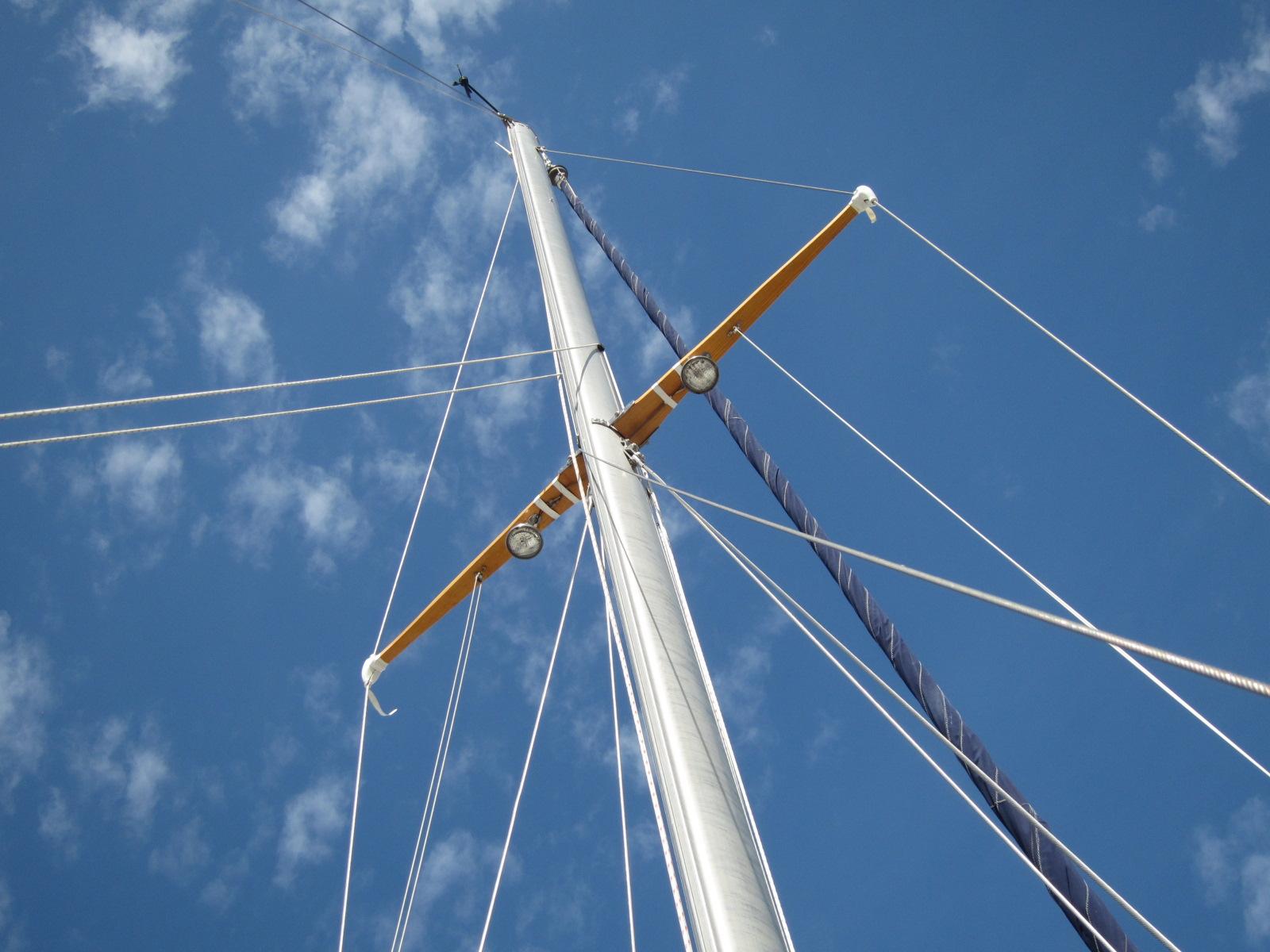 Mast of 1969 Chris-Craft Apache 37 sailboat against a clear blue sky.