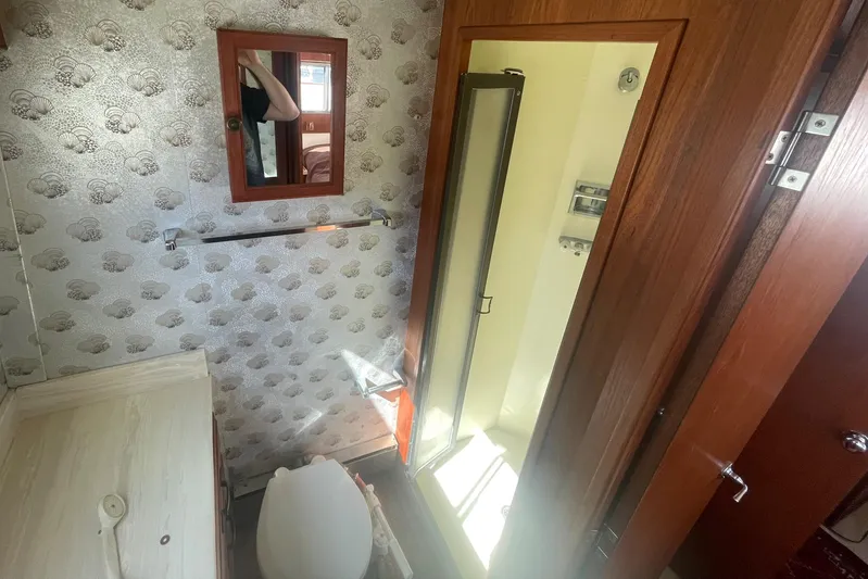  Yacht Photos Pics 1981 Tollycraft 48 Motor Yacht bathroom with shower, toilet, and vanity.