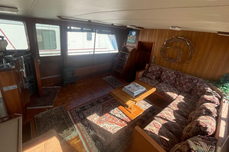  Yacht Photos Pics 1981 Tollycraft 48 Motor Yacht interior with cozy seating and wooden decor.
