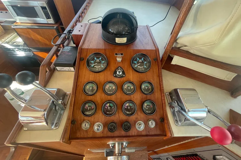  Yacht Photos Pics Control panel of a 1981 Tollycraft 48 Motor Yacht with gauges and levers.