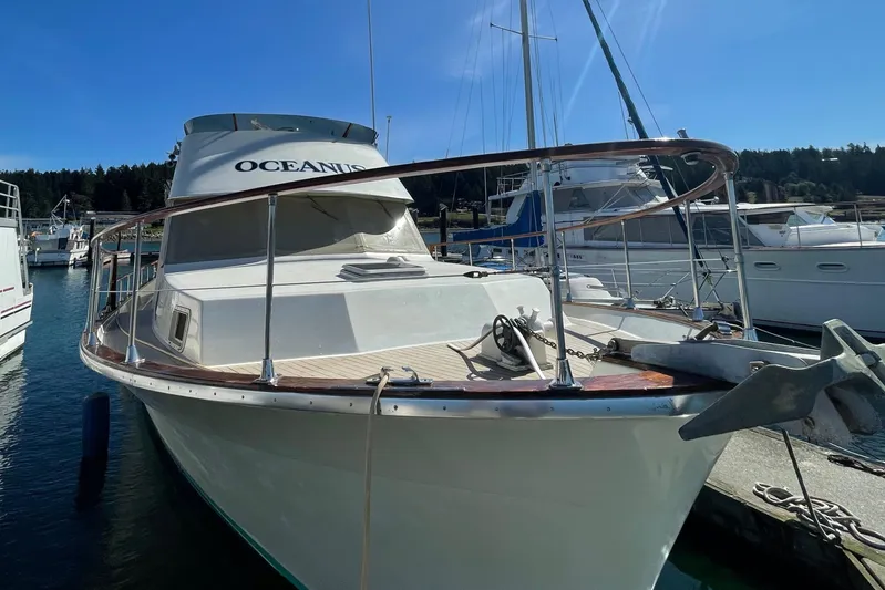  Yacht Photos Pics 1981 Tollycraft 48 Motor Yacht docked in a marina on a sunny day.