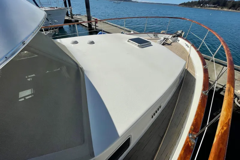  Yacht Photos Pics 1981 Tollycraft 48 Motor Yacht docked, showcasing the spacious deck and sleek design.