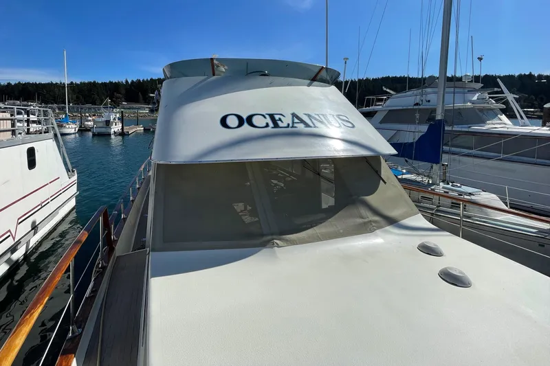  Yacht Photos Pics 1981 Tollycraft 48 Motor Yacht Oceanus docked at a marina on a sunny day.