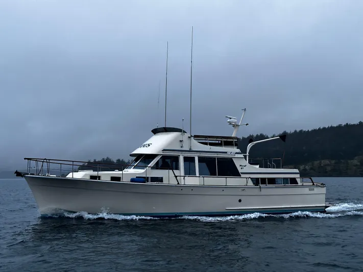  Yacht Photos Pics 1981 Tollycraft 48 Motor Yacht cruising on a cloudy day.