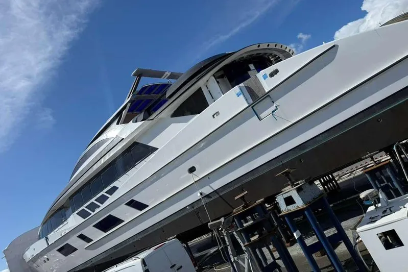 1992/2016 Heesen Motor Yacht Yacht Photos Pics Heesen 141 Motor Yacht 1992 on dry dock under clear blue sky.