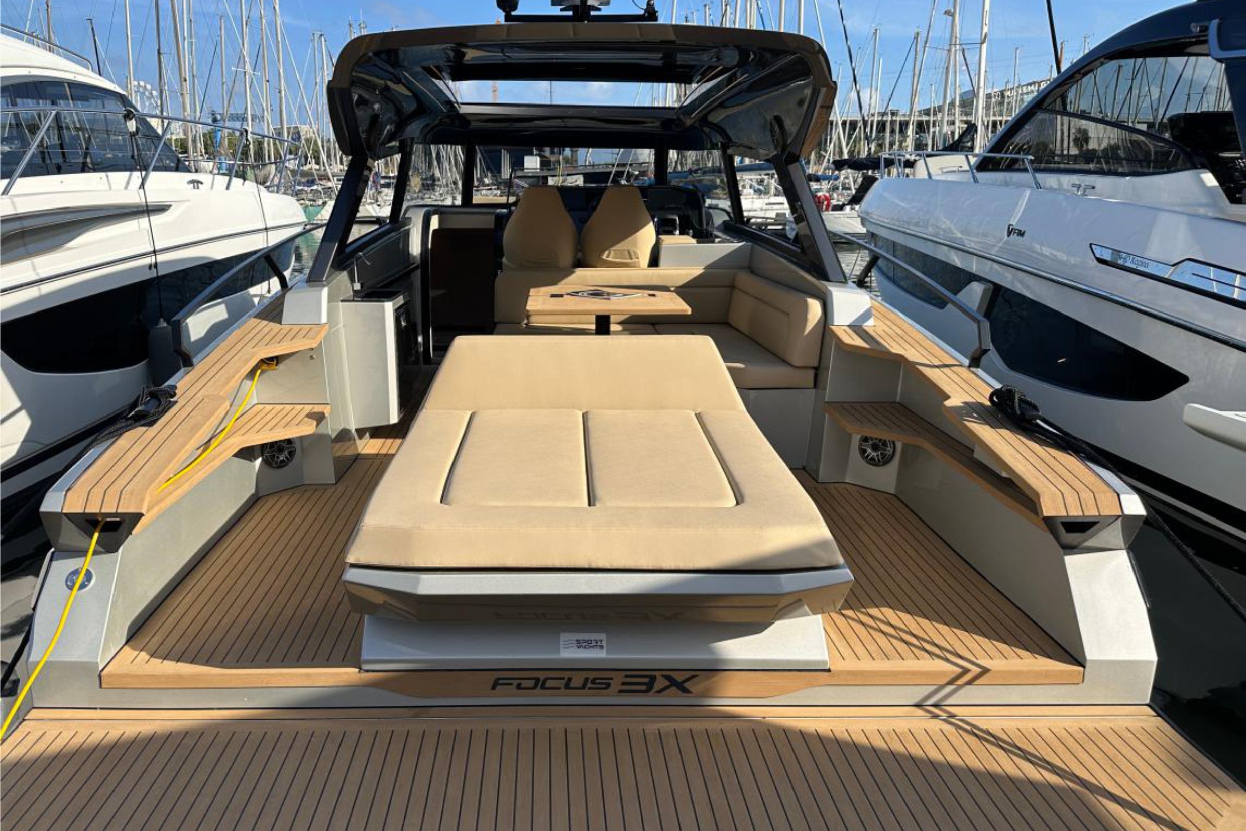 Luxurious 2025 Focus 3X yacht with spacious deck and modern seating at marina.