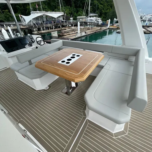 Leopard 40pc Yacht Photos Pics 2025 Leopard 40PC yacht deck with seating and wooden table, docked at marina.