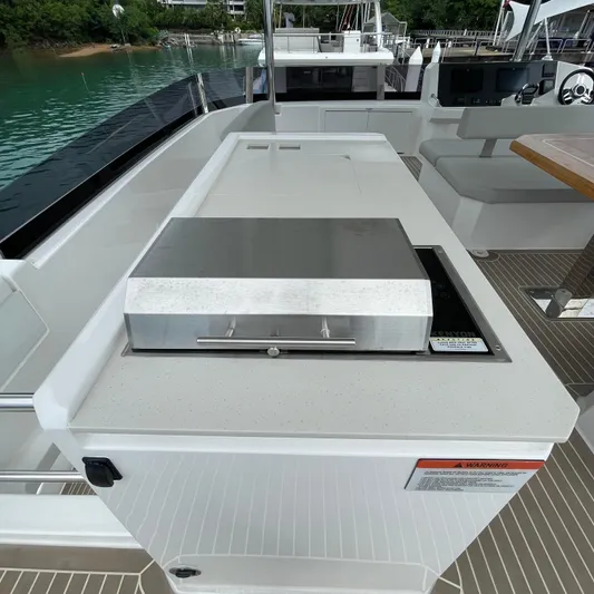 Leopard 40pc Yacht Photos Pics Outdoor kitchen area on a 2025 Leopard 40PC yacht with grill and seating.