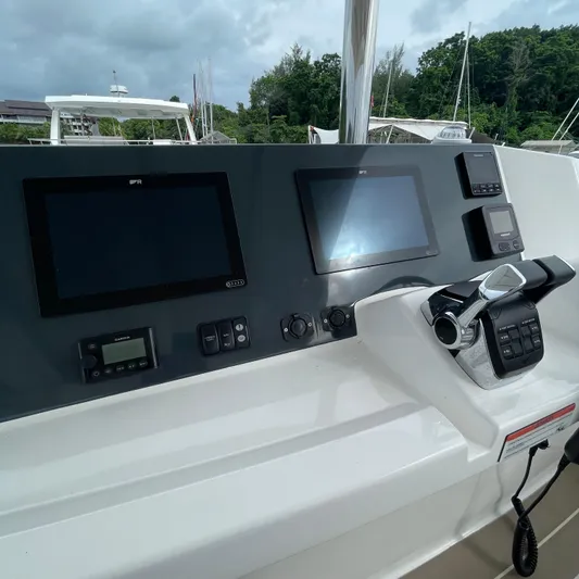Leopard 40pc Yacht Photos Pics Control panel of 2025 Leopard 40PC yacht with navigation screens and throttle.