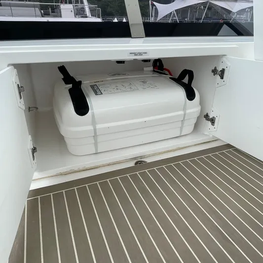 Leopard 40pc Yacht Photos Pics Storage compartment on 2025 Leopard 40PC boat with secured white container.