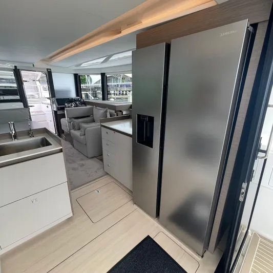 Leopard 40pc Yacht Photos Pics Luxurious interior of 2025 Leopard 40PC yacht with modern kitchen and seating area.