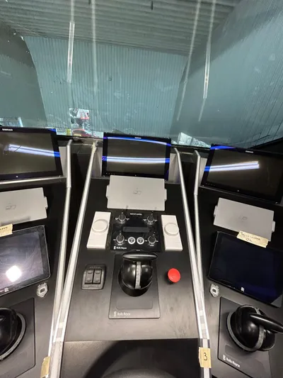 1992/2016 Heesen Motor Yacht Yacht Photos Pics Control panel of a 1992 Heesen 141 Motor Yacht with multiple screens and controls.