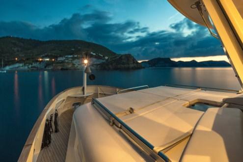 Italian Trawler yacht at sunset, 2009 Explorer model, docked near scenic coastline.