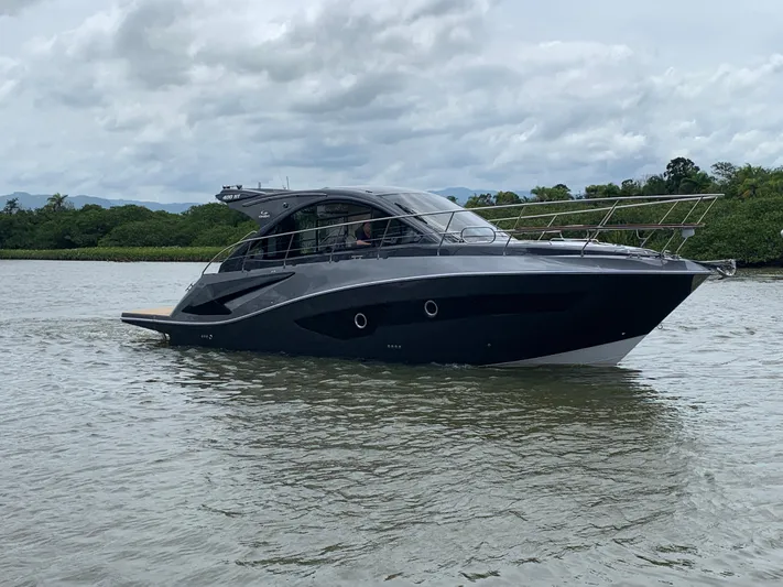 Saviour Yacht Photos Pics 2022 Evolve 400HT yacht cruising on a calm river under cloudy skies.