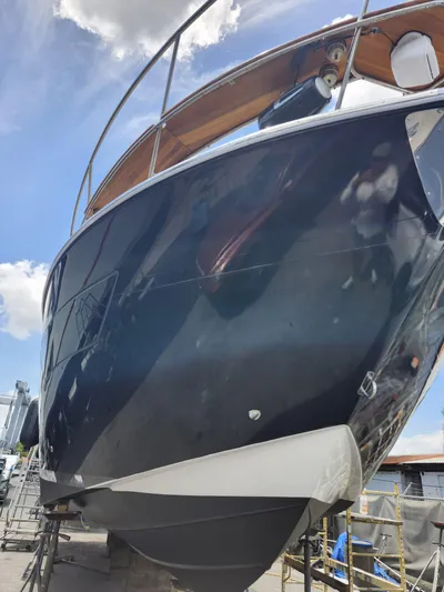 Saviour Yacht Photos Pics 2022 Evolve 400HT yacht, sleek design, docked under blue sky.