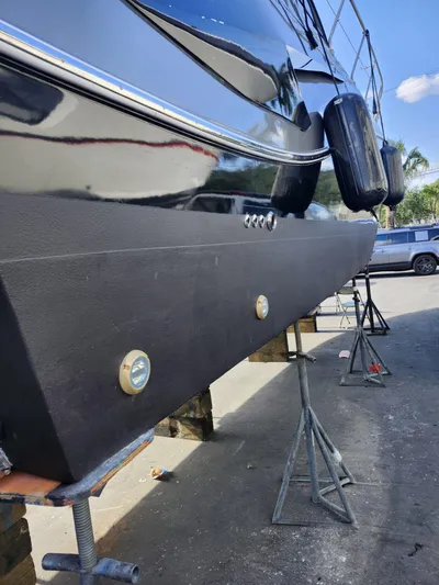 Saviour Yacht Photos Pics 2022 Evolve 400HT yacht on stands, black hull, outdoor setting.