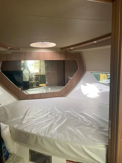Saviour Yacht Photos Pics Interior of 2022 Evolve 400HT boat cabin with round bed and mirror.