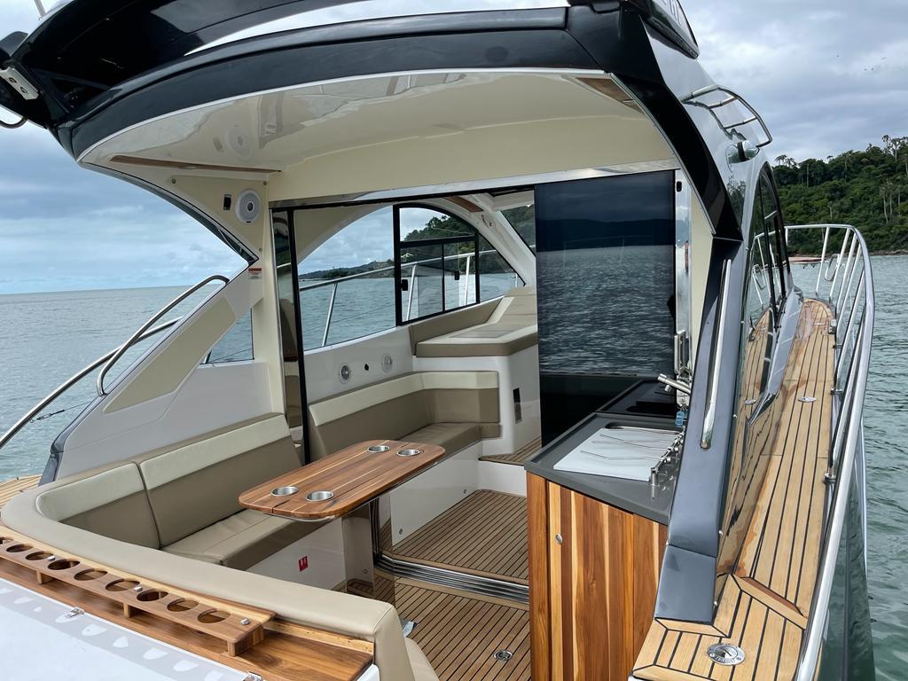 Luxury Evolve 400HT yacht interior, 2022 model, featuring elegant seating and wooden accents.