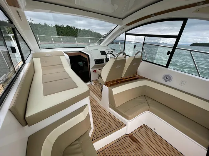 Saviour Yacht Photos Pics Luxurious interior of 2022 Evolve 400HT yacht with beige seating and wood flooring.
