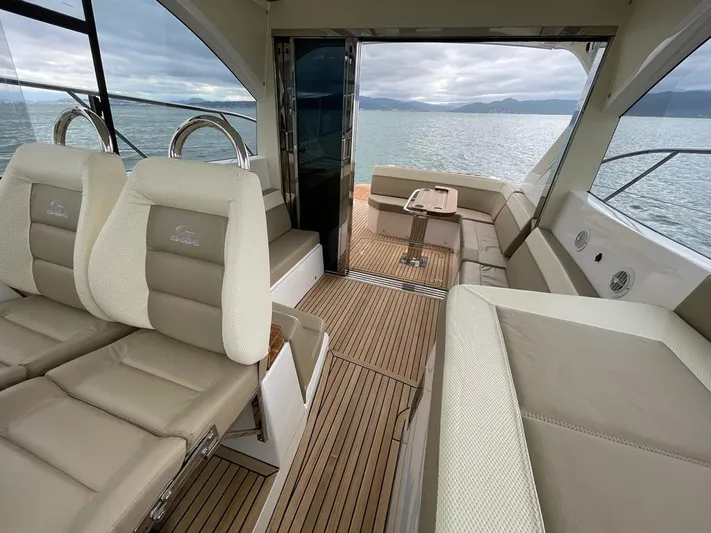 Saviour Yacht Photos Pics Luxurious interior of 2022 Evolve 400HT yacht with beige seating and wooden flooring.