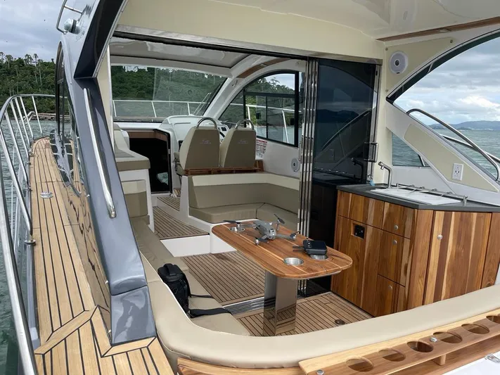 Saviour Yacht Photos Pics Luxurious 2022 Evolve 400HT yacht interior with sleek wood finishes and modern seating.