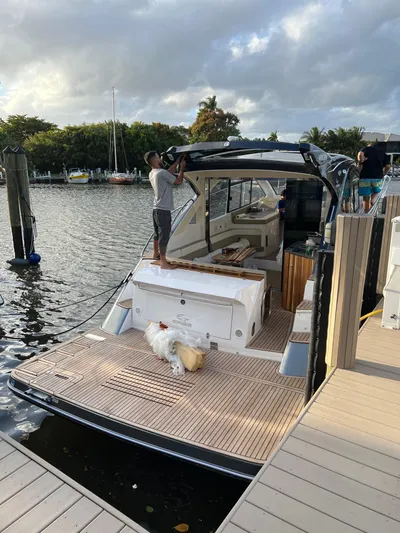 Saviour Yacht Photos Pics Man working on 2022 Evolve 400HT yacht docked by a scenic waterfront.