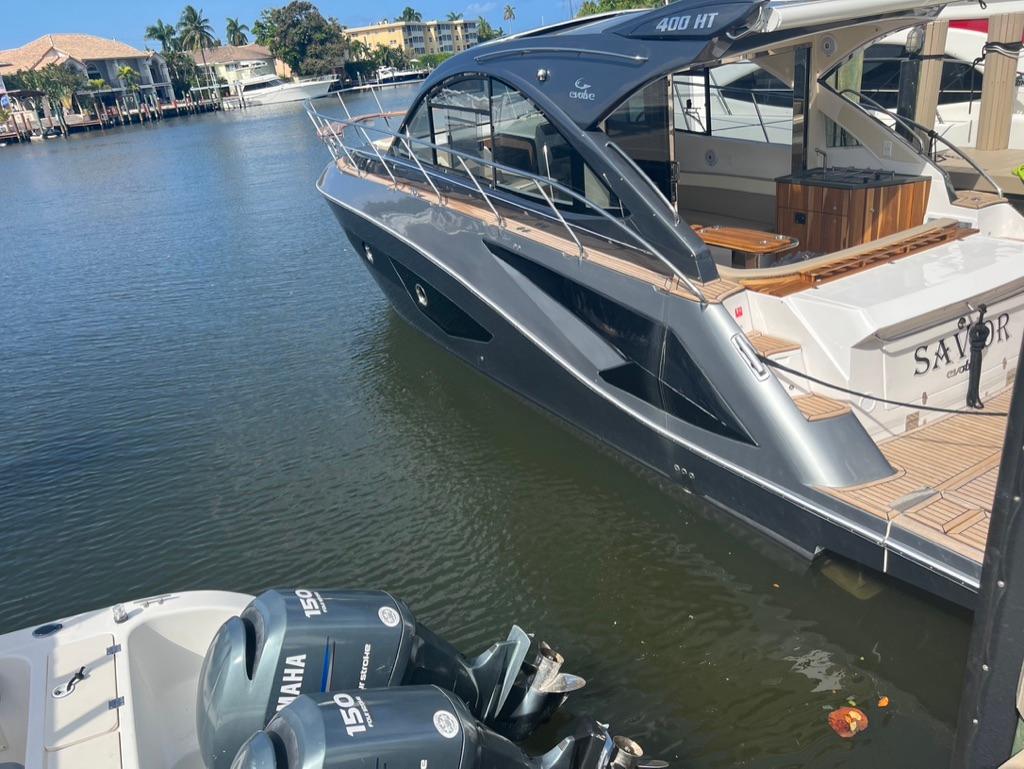 Luxury Evolve 400HT yacht docked by waterfront, 2022 model, with Yamaha engines visible.