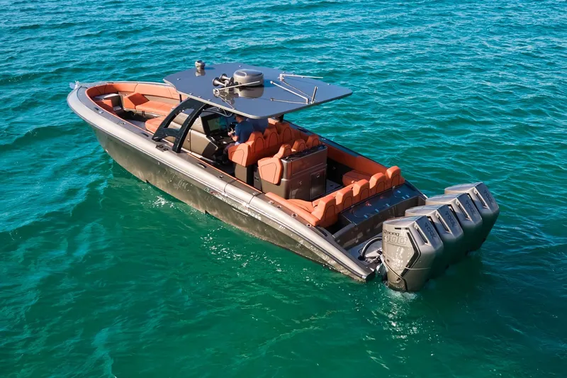  Yacht Photos Pics Midnight Express 37' Open boat with orange seating on clear blue water.