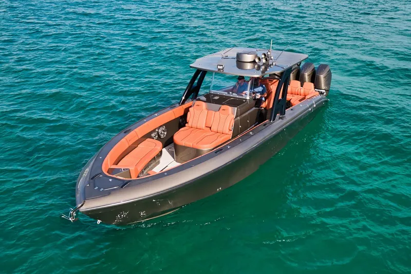  Yacht Photos Pics Midnight Express 37' Open boat on clear blue water, featuring sleek design and orange seating.