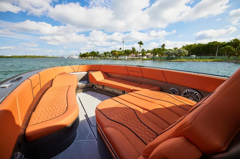  Yacht Photos Pics Luxurious interior of Midnight Express 37' Open boat with orange seating, on a sunny day.